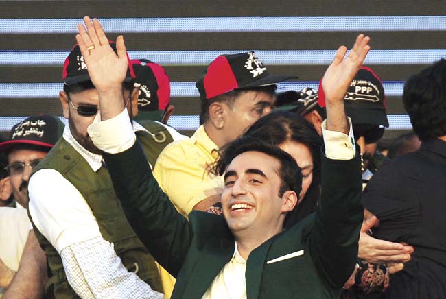 Bilawal Bhutto Zardari (C), chairman of Pakistan Peoples Party (PPP), waves to supporters during his arrival for a public gathering in Karachi on October 18, 2014. Tens of thousands of PPP supporters gathered in Karachi to hear Bilawal Bhutto Zardari, the son of the country’s slain premier Benazir Bhutto, on the formal launch of his political career. Pic/Getty Images