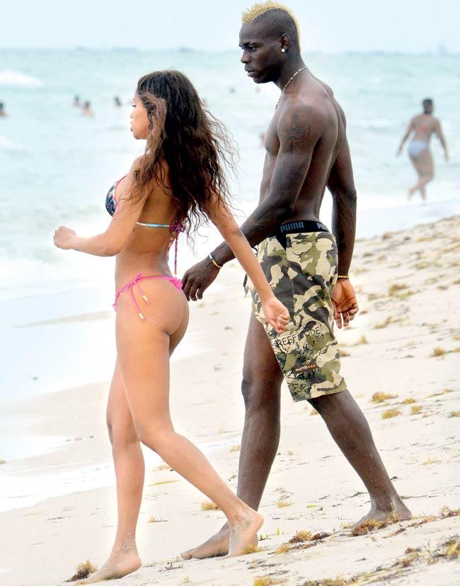 Before the split: Mario Balotelli with then girlfriend Fanny Neguesha at Miami Beach on July 6, 2014. Neguesha, who split with Balotelli last month, left him for a month in 2013 when he said that if Real Madrid make it to the Champions League final, he would let Neguesha sleep with all their players. Pic/Getty Images