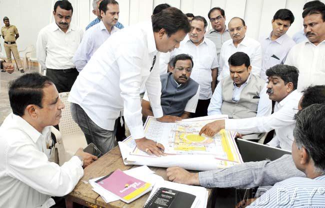 Art director Nitin Chandrakant Desai points at a plan of the Wankhede stadium, during a discussion with CM-designate Devendra Fadnavis and other senior BJP leaders yesterday. Pics/Deepak Salvi