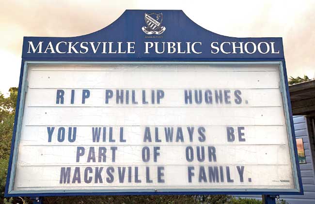 A school displays a message in memory of the departed cricketer. Pics/AFP, Getty Images
