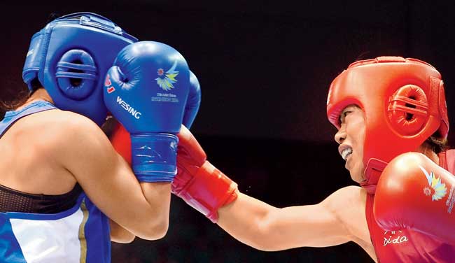 Mary Kom (right) punches Zhaina at the Seonhak Gymnasium. Pic/AFP 
