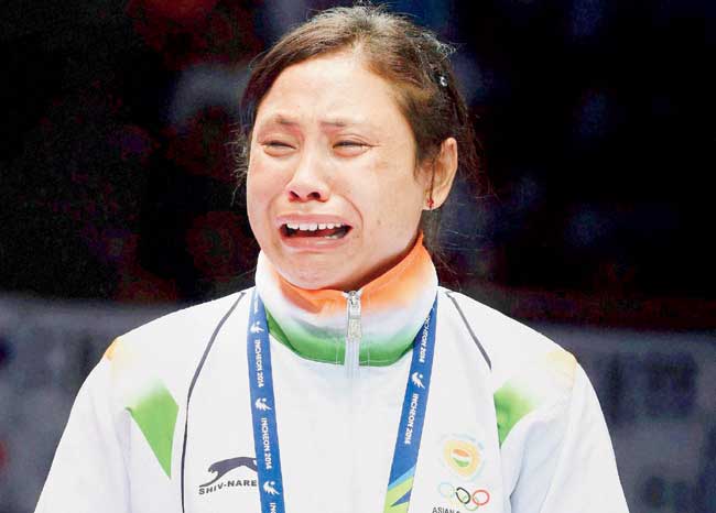 L Sarita Devi in tears atop the victory podium on Wednesday