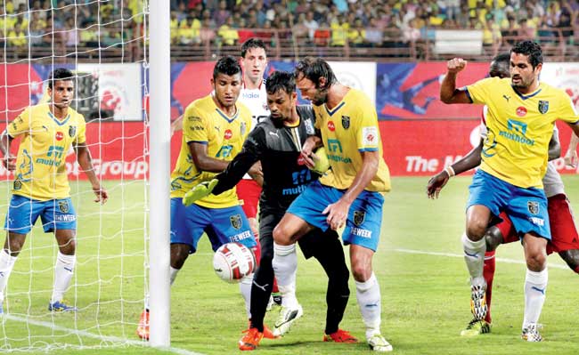 Kerala Blasters FC players prevent the ball from entering the goal at Kochi