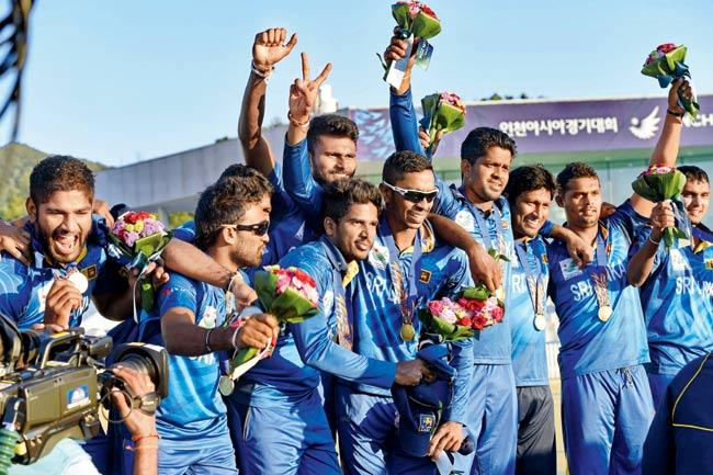 The Sri Lankan team celebrates winning gold after beating Afghanistan in the cricket final. Pic/PTI