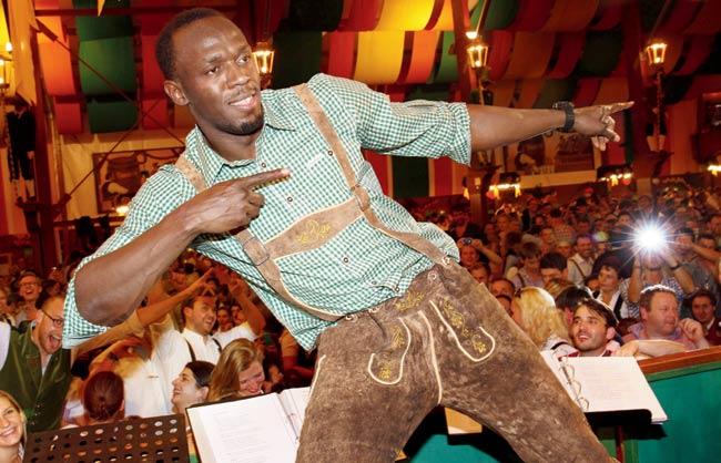 Usain Bolt does his signature celebration at the Oktoberfest