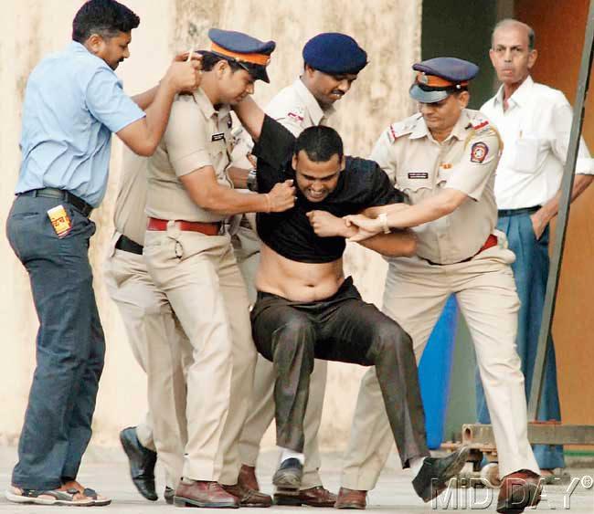 Police officials nab a spectator at the Wankhede yesterday. Pic/Atul Kamble