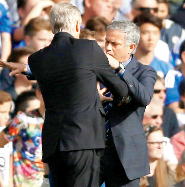 Arsenal boss Arsene Wenger (left) pushes Chelsea manager Jose Mourinho. Pic/Getty Images