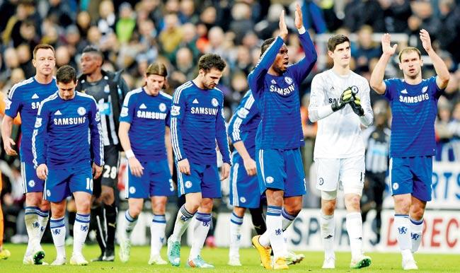 Dejected Chelsea players applaud the travelling fans following their team