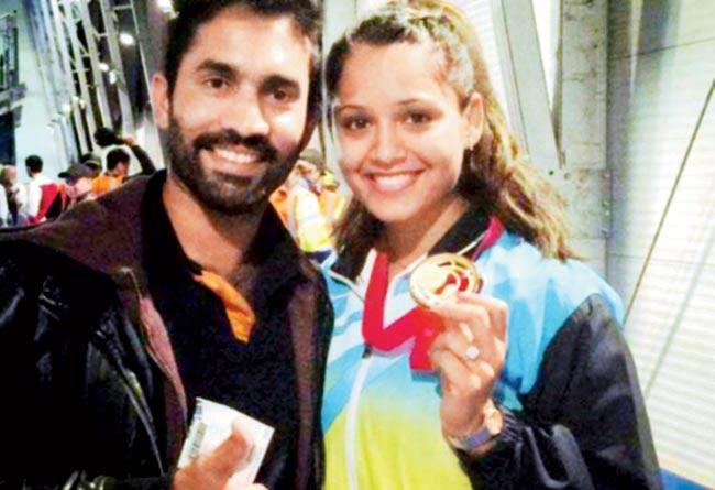 Dinesh Karthik with Dipika Pallikal after she won gold in the squash women