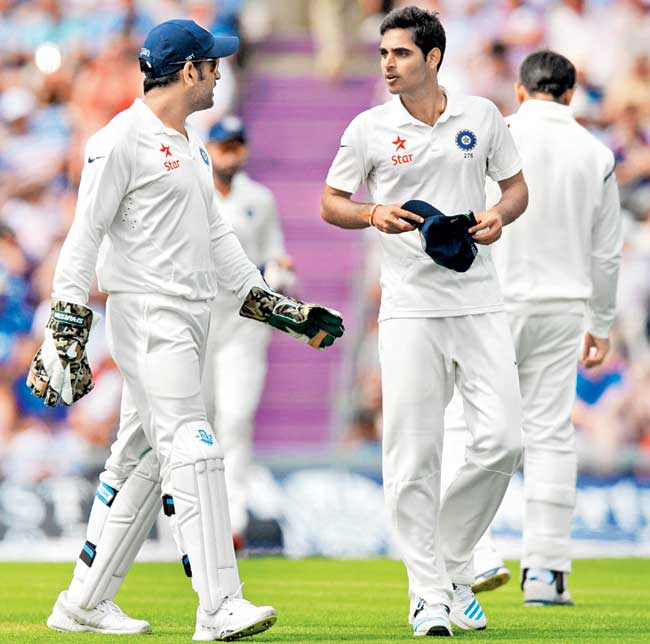 MS Dhoni talks to Bhuvneshwar Kumar during the third Test against England at Southampton in July. Pic/AFP