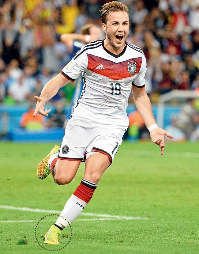 Mario Goetze celebrates after scoring in the 2014 World Cup final against Argentina. His left boot (encircled) fetched USD 2.45 million at a charity event in Berlin on Saturday