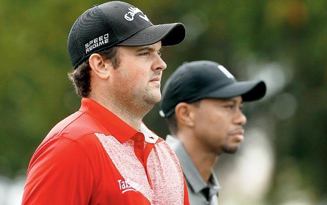 Patrick Reed (left) and Tiger Woods walk off the third tee during the second round of the Hero World Challenge. Pic/AFP