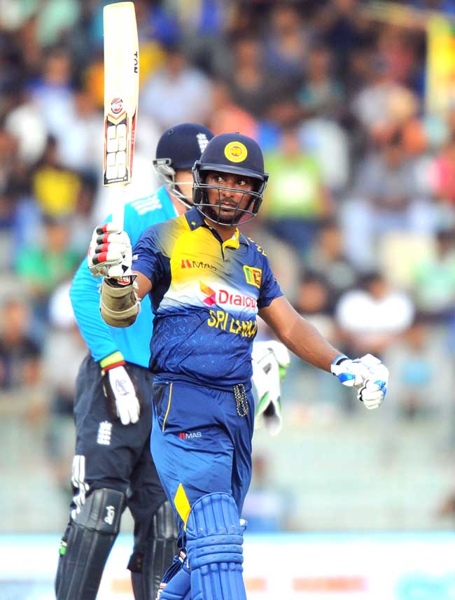 Sri Lankan cricketer Kumar Sangakkara reacts after scoring a half century (50 runs) during the fourth One Day International (ODI) match between Sri Lanka and England at the R. Premadasa Cricket Stadium in Colombo. Pic/AFP