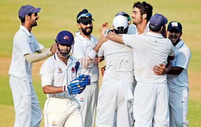 Jammu & Kashmir players celebrate the wicket of Mumbai