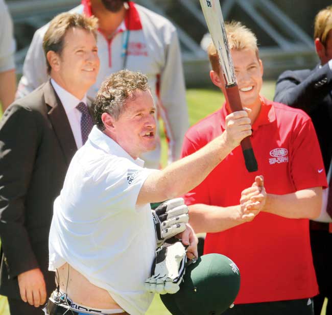 Piers Morgan acknowledges the crowd after facing deliveries from former Australia cricketer Brett Lee (r) as commentator Mark Nicholas looks on during the Melbourne Ashes Test last year. Pic/Getty Images