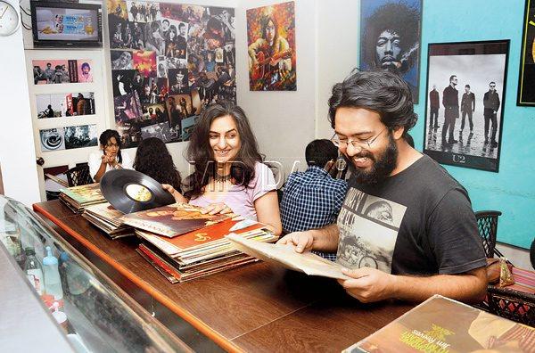 < Arpana Gvalani and Suvajeet Duttagupta at the vinyl record sale that was organised in early December