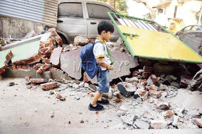 The horror and confusion was evident on this tiny tot’s face when he saw what had become of the school’s boundary wall