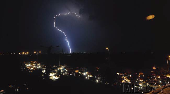 Lightning seen above an under-construction building in Wadala and on the highway near Ghatkopar. Met department says thundershowers will continue to hit the city in the next two days. Pics/Sameer Markande and Shadab Khan
