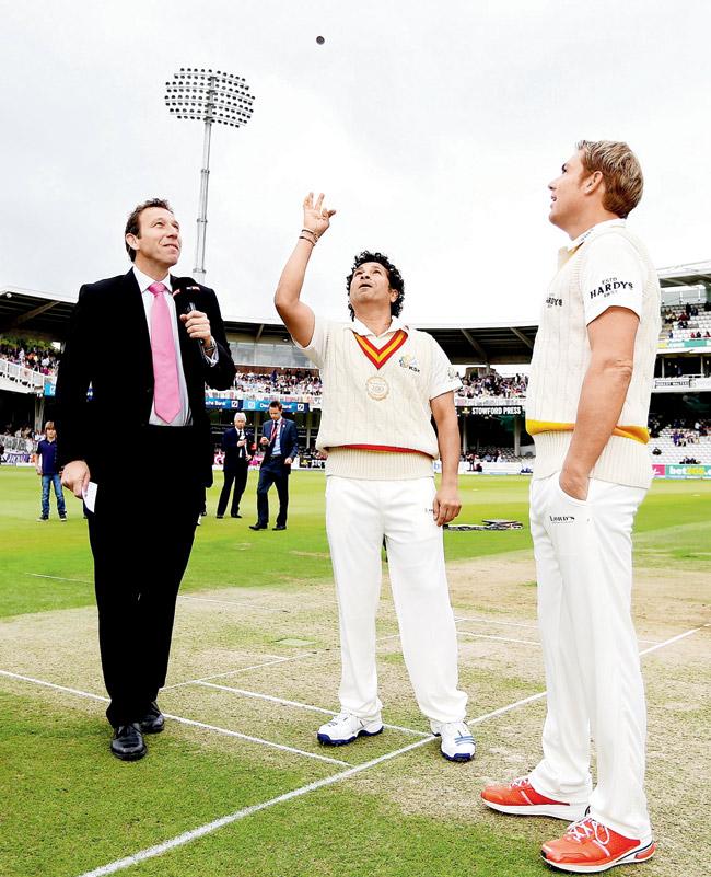 MCC captain Sachin Tendulkar tosses the coin alongside Rest of the World captain Shane Warne during the MCC and Rest of the World match at Lord’s cricket ground in 2014
