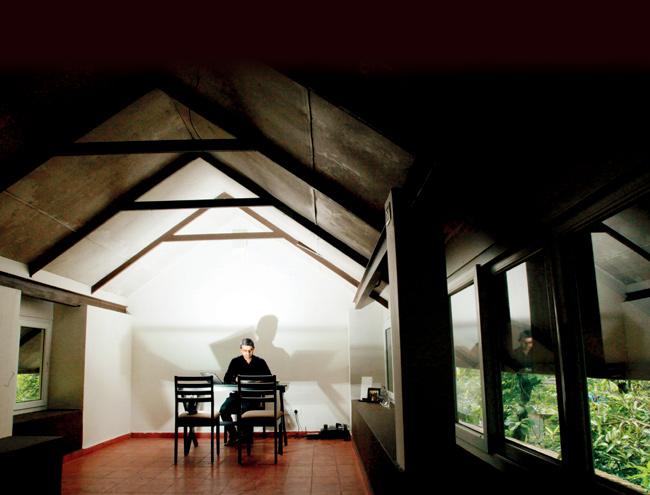 James Joseph at work in his back-up office, located in his attic, in Aluva, Kerala