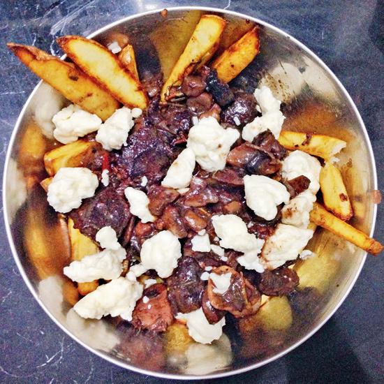 Poutine, a concoction from Quebec, Canada, combines crispy fries, gravy and cheese curds