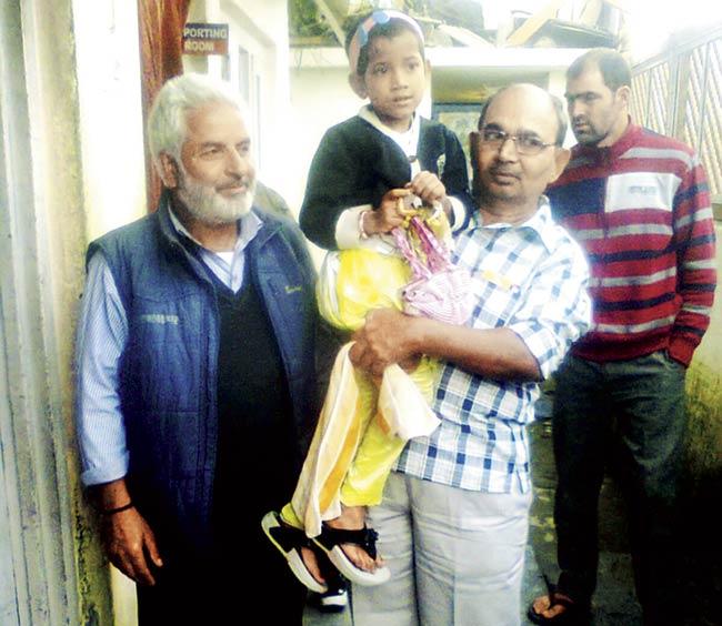 Megha with her grandfather Rakesh Thakur and her saviour Abdul Shaikh in Srinagar yesterday morning