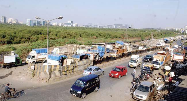 With half of the Mahim-Dharavi bridge closed for repairs, several trucks and other vehicles have been parked here illegally, while the remaining half of the bridge is supporting two-way traffic. Pic/Shadab Khan