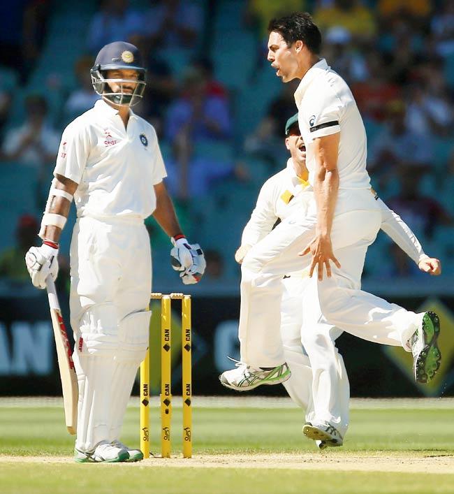 Mitchell Johnson celebrates the wicket of Shikhar Dhawan in Adelaide