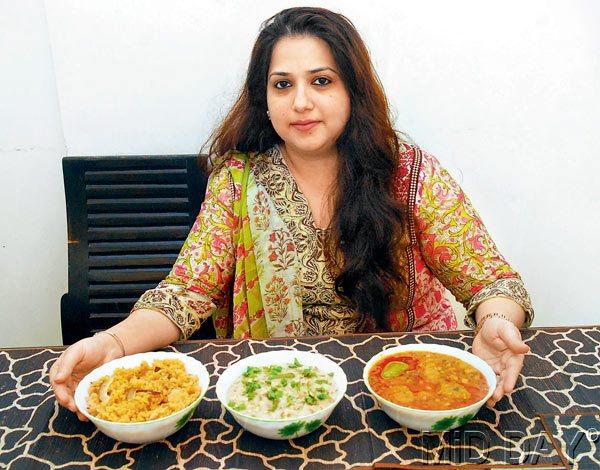 Sanah Gubitra at her Bandra residence with bowls of Muthia, Naram Khichadi and Lapai, which is a popular Cutchi Memon dessert. 