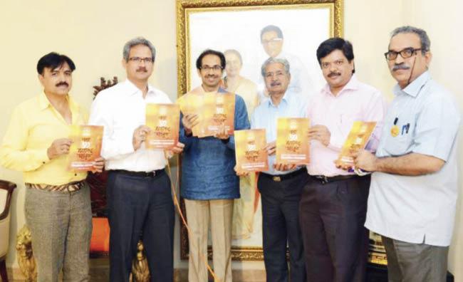 Sena (left) and BJP leaders (above) with their respective manifestos yesterday. Pics/Rajesh Varadkar and Atul Kamble