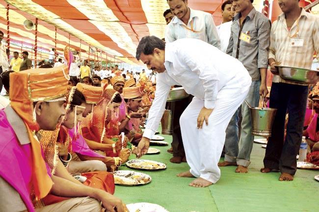 Subhash Deshmukh distributes food to the couples at one of the community weddings he organises each year