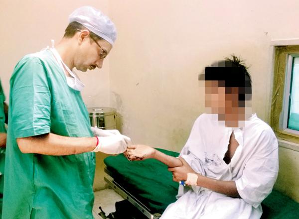 Dr Rajat Gupta from JJ Hospital with 13-year-old Kiran Sathavali. The doctor said that while they have been able to save three of the teen’s fingers, they may have to amputate his little finger