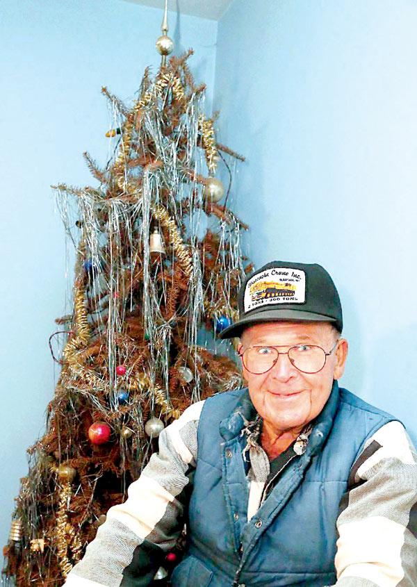 Neil Olson with his tree. pic/ap
