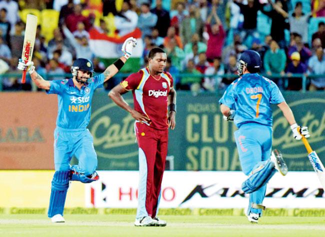 Virat Kohli celebrates after reaching three-figure mark