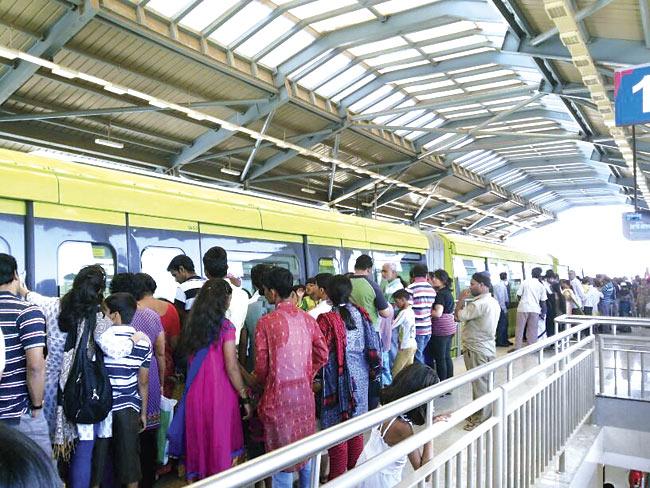 Monorail commuters wait at the stations at Wadala and Chembur on Sunday, as delays daunt services