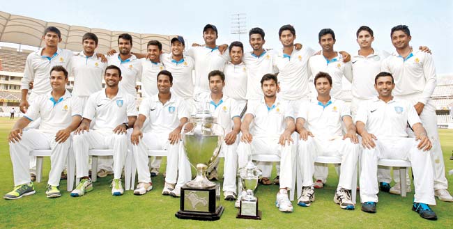 Champions: Ranji Trophy 2013-14 champions Karnataka with the trophy after defeating Maharashtra in the final at the Rajiv Gandhi International Stadium in Uppal, Hyderabad yesterday. Standing (from left): Ganesh Satish, R Samarth, Abrar Kazi, Shreyas Gopal, Mayank Agarwal, HS Sharath, Karun Nair, KL Rahul, Ronit More, Amit Verma, Kunal Kapoor, KP Appanna. Sitting (from left): Stuart Binny, Abhimanyu Mithun, CM Gautam, R Vinay Kumar (captain), Manish Pandey, S Arvind, Robin Uthappa