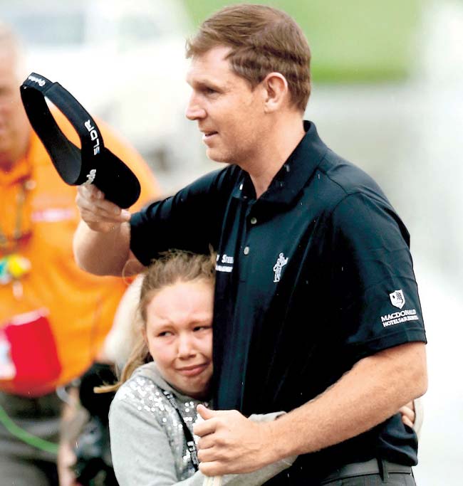 Stephen Gallacher is greeted by his emotional daughter Ellie after his Dubai Desert Classic win yesterday