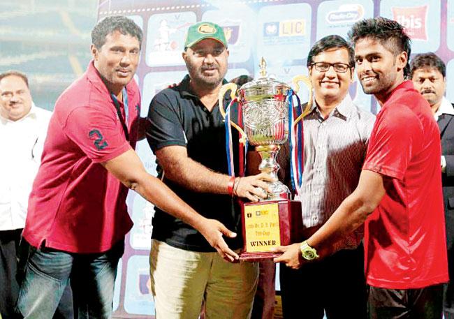Suryakumar Yadav (right) receives the Dr DY Patil T20 Cup from former cricketers Abey Kuruvilla (left) and Balvinder Singh Sandhu.  MCA