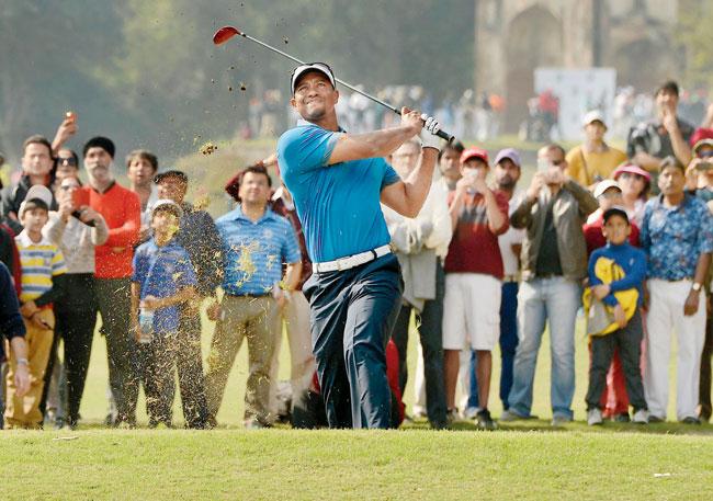 Tiger Woods tees off at the Delhi Golf Club yesterday