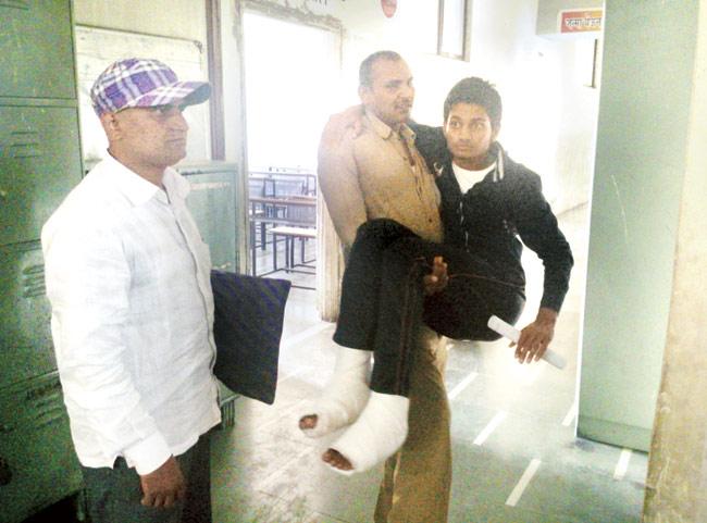 Ankit Yadav’s father (left) and uncle (carrying him) took him to his centre in Borivali for his English paper yesterday