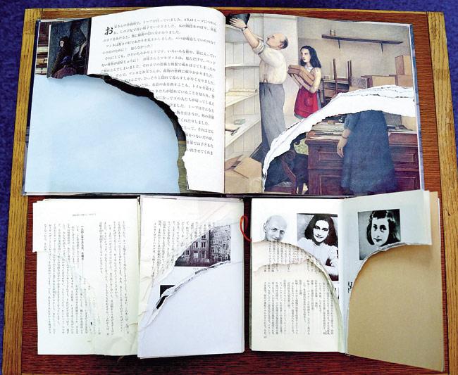 Torn pages of Anne Frank’s Diary of Young Girl are displayed at a library in Tokyo. Pic/AFP