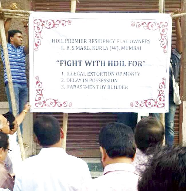 Several homebuyers, who booked flats at Premier Residences in Kurla (W) in 2009, are protesting against the builder’s unreasonable demand of extra charges. They were assured of possession in 2010, but four years later, they are still waiting. Pic/Atul Kamble