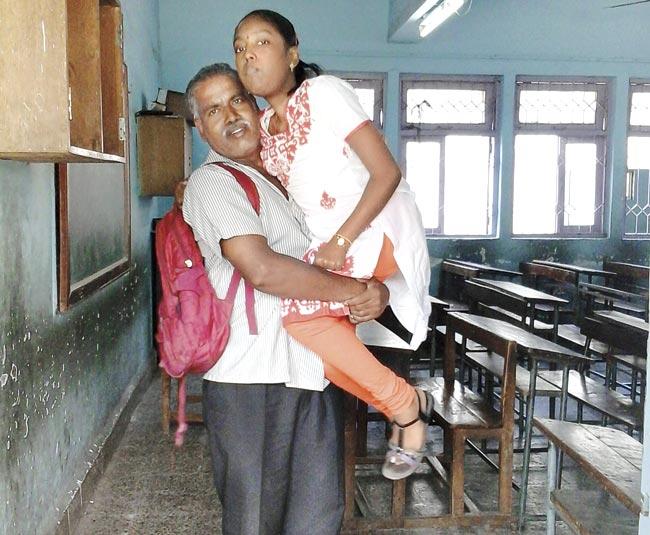Newspaper vendor Murugan Yadav carries his daughter Mahalakshmi, who is suffering from muscular dystrophy, to the exam centre every day