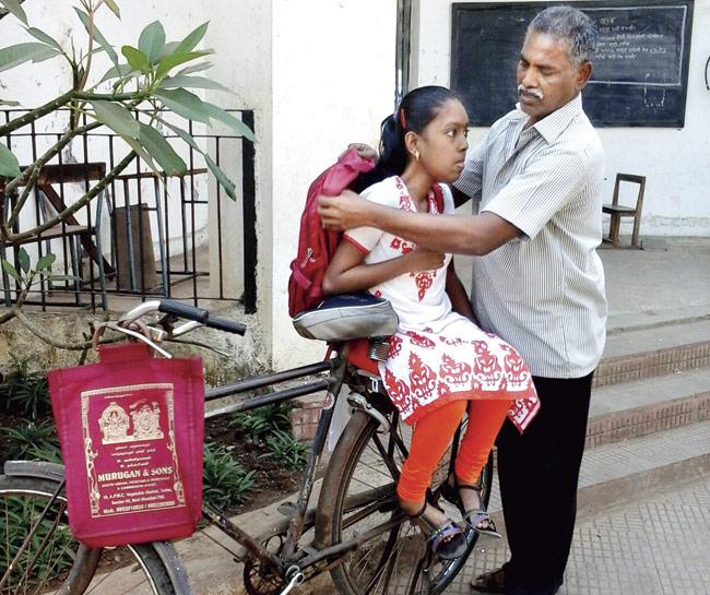 Murugan has made some changes to the carrier of his bicycle, so that Mahalakshmi can set herself comfortably while riding pillion, to reach her classes and exam halls