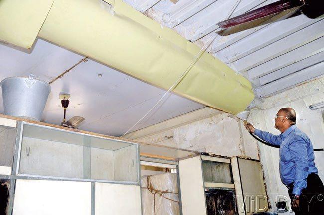 Mitesh Modi, a resident, shows the contraption put up to capture the constantly leaking water from the roof and store it in a tank. Pics/Bipin Kokate