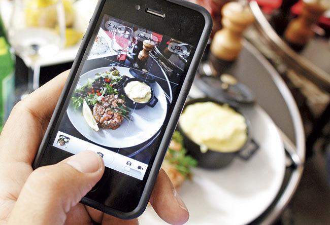 A few chefs complain that patrons are so busy taking pictures of the food and posting them on social media that the surprise element is lost. Pic/AFP