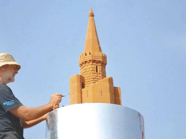 Simon Smith begins working on the spire of the castle