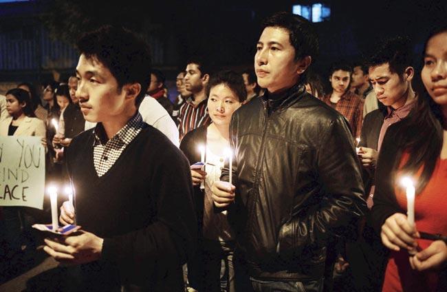 Students and supporters hold placards and candles during a protest in New Delhi against student Nido Taniam’s death. Pic/AFP