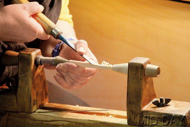 A woodcarver crafts a tree on a lathe in Seiffener Volkskunst. Pics/Kalpana Sunder