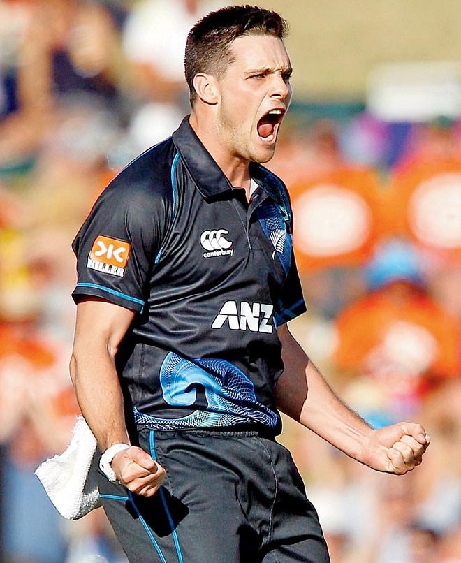 Mitchell McClenaghan celebrates the wicket of Rohit Sharma yesterday